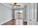 Bedroom features a ceiling fan, sliding glass doors, and neutral paint at 115 Oyster Bay Cir # 260, Altamonte Springs, FL 32701