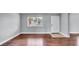 Bright living room boasts gorgeous hardwood floors and a large window for ample sunlight at 115 Oyster Bay Cir # 260, Altamonte Springs, FL 32701