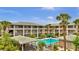 Beautiful condo complex featuring a refreshing swimming pool surrounded by lush landscaping at 115 Oyster Bay Cir # 260, Altamonte Springs, FL 32701