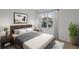 Stylishly staged bedroom with modern furniture, neutral color scheme, and natural light from the window at 1315 Lawndale Cp, Ormond Beach, FL 32174