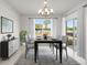 Contemporary dining room with modern chandelier, neutral gray chairs, and view to the yard at 1315 Lawndale Cp, Ormond Beach, FL 32174