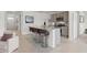 Open concept kitchen featuring stone countertops, stainless appliances, and bar stool seating at the island at 1315 Lawndale Cp, Ormond Beach, FL 32174