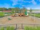 Aerial view of a playground with swings, slides, and picnic shelter within a fenced area at 1315 Lawndale Cp, Ormond Beach, FL 32174