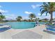 Large community pool with ample seating, palm trees, and a zero-entry access at 1315 Lawndale Cp, Ormond Beach, FL 32174