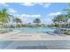 Resort-style pool with shallow beach entry, community seating and lush landscaping at 1315 Lawndale Cp, Ormond Beach, FL 32174