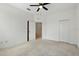 Carpeted bedroom with ceiling fan, walk-in closet and ensuite access at 13329 Harbor Shore Ln, Winter Garden, FL 34787