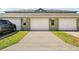 A long driveway leads to the garages of the townhomes which sit adjacent to the well-maintained landscaping at 13329 Harbor Shore Ln, Winter Garden, FL 34787