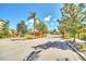 Gated entrance into the community, framed by brick pillars, landscaping, and trees under a clear, sunny sky at 13329 Harbor Shore Ln, Winter Garden, FL 34787