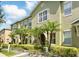 Charming townhome showcasing a well-manicured lawn and verdant landscaping at 13329 Harbor Shore Ln, Winter Garden, FL 34787
