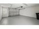 Spacious two-car garage with a freshly painted floor providing ample room for parking and storage at 13329 Harbor Shore Ln, Winter Garden, FL 34787
