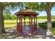 Wooden gazebo with seating, providing a serene spot to enjoy the lake view at 13329 Harbor Shore Ln, Winter Garden, FL 34787