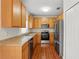 Efficient kitchen featuring stainless steel appliances, wooden cabinets, and laminate countertops at 13329 Harbor Shore Ln, Winter Garden, FL 34787