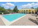 Community pool featuring lounge chairs and yellow clubhouse, perfect for relaxing and socializing at 13329 Harbor Shore Ln, Winter Garden, FL 34787