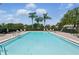 Community pool surrounded by lounge chairs, offering a refreshing oasis for residents to enjoy at 13329 Harbor Shore Ln, Winter Garden, FL 34787