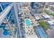 High-angle view showing swimming pool and outdoor seating, plus tennis courts and building facade at 150 E Robinson St # 2408, Orlando, FL 32801