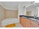 Bathroom featuring dual sinks and a soaking tub at 150 E Robinson St # 2408, Orlando, FL 32801