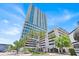 Contemporary high-rise building with modern architecture, blue glass windows, and lush palm trees at 150 E Robinson St # 2408, Orlando, FL 32801