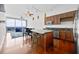 Modern kitchen with stainless steel appliances, island seating, and a view of the city skyline at 150 E Robinson St # 2408, Orlando, FL 32801
