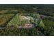 Aerial view of acreage featuring a large property with mature trees at 1555 Seminole Run Rd, Osteen, FL 32764