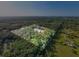 Aerial view of a sprawling acreage with a tree lined perimeter at 1555 Seminole Run Rd, Osteen, FL 32764