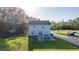 A spacious backyard featuring a patio with outdoor seating, grassy lawn and a detached tree house at 1555 Seminole Run Rd, Osteen, FL 32764