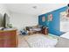 Bright bedroom with a wood floor, blue accent wall, and bunk bed at 1555 Seminole Run Rd, Osteen, FL 32764