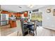 Open dining area connected to the kitchen with wood-look floors and backyard access at 1555 Seminole Run Rd, Osteen, FL 32764