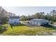 A light blue two-story home with a large detached garage and a gravel driveway on a spacious lot at 1555 Seminole Run Rd, Osteen, FL 32764