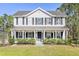 Inviting two-story home featuring a classic design, covered porch, and beautiful curb appeal at 1555 Seminole Run Rd, Osteen, FL 32764