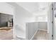 A light and bright hallway with hard wood floors and a railing leading to the bedrooms at 1555 Seminole Run Rd, Osteen, FL 32764