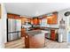 Bright kitchen with wood floors, stainless appliances, granite counters and a center island perfect for entertaining at 1555 Seminole Run Rd, Osteen, FL 32764