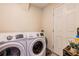 Modern laundry room with front-loading washer and dryer at 1555 Seminole Run Rd, Osteen, FL 32764