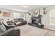 Spacious living room with fireplace and comfortable seating, perfect for entertaining and relaxing at 1555 Seminole Run Rd, Osteen, FL 32764
