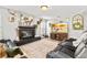 Inviting living room featuring a fireplace, TV and comfortable seating, ideal for relaxation at 1555 Seminole Run Rd, Osteen, FL 32764