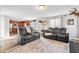 Cozy living room with leather seating and an open view to the kitchen, perfect for gatherings at 1555 Seminole Run Rd, Osteen, FL 32764