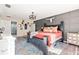 The main bedroom has wood floors, a large bed, an accent wall and a full dresser at 1555 Seminole Run Rd, Osteen, FL 32764