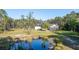 View of the home and the pond, showcasing the beautiful nature surrounding the property at 1555 Seminole Run Rd, Osteen, FL 32764