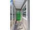 View of a back porch with a green door and lots of windows at 1611 Creekwood Run, Lakeland, FL 33809