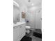 Modern bathroom features glass shower stall and geometric-patterned flooring at 1611 Creekwood Run, Lakeland, FL 33809