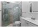 Modern bathroom featuring a glass enclosed shower with marble style tiling and a white vanity at 1611 Creekwood Run, Lakeland, FL 33809