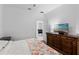 Bright bedroom featuring a wooden dresser, a television and carpeted floor at 1611 Creekwood Run, Lakeland, FL 33809