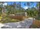 Charming home featuring a wooden fence, mailbox, and driveway leading to the house surrounded by trees at 1611 Creekwood Run, Lakeland, FL 33809
