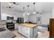 Open kitchen featuring stainless appliances, granite counters and island with butcher block top at 1611 Creekwood Run, Lakeland, FL 33809