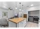 Bright kitchen with center island and stainless appliances, adjacent to living space at 1611 Creekwood Run, Lakeland, FL 33809
