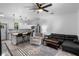 Open-concept living room and kitchen featuring modern furniture and fixtures at 1611 Creekwood Run, Lakeland, FL 33809