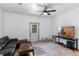 Bright living room featuring modern furnishings with a TV and a view of the outdoors at 1611 Creekwood Run, Lakeland, FL 33809