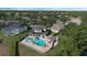 An overhead view of a home with an inviting backyard including a pool, spa, cabana, and outdoor kitchen at 1710 Bridgets Ct, Kissimmee, FL 34744