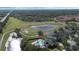 Expansive aerial view of the property featuring a lush golf course and serene water feature at 1710 Bridgets Ct, Kissimmee, FL 34744