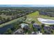 Aerial view of property next to golf course, featuring a pool and solar panels on roof at 1710 Bridgets Ct, Kissimmee, FL 34744