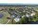 Stunning aerial view of the property with a great pool and golf course in the background at 1710 Bridgets Ct, Kissimmee, FL 34744